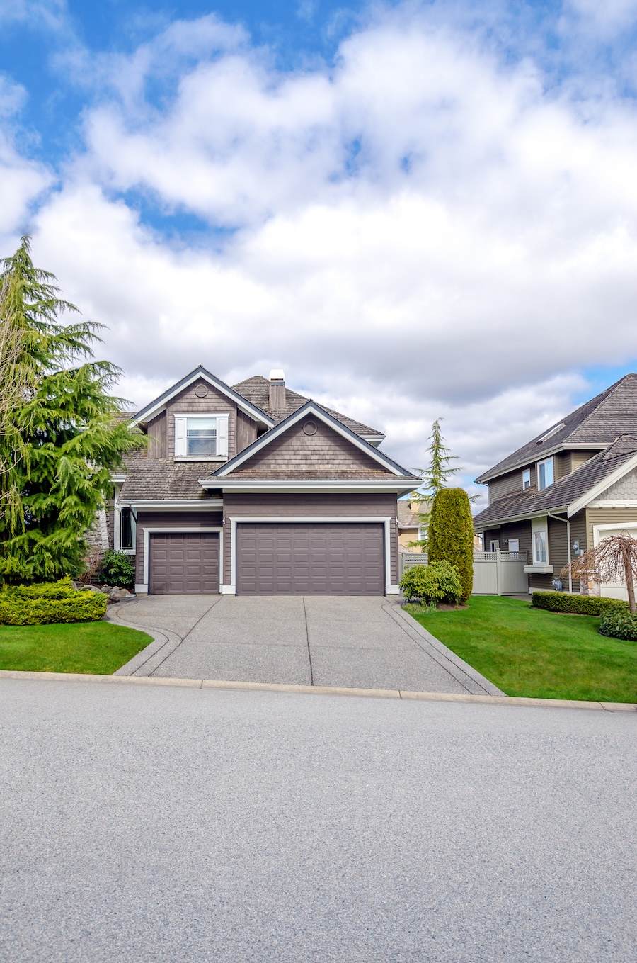 Suburban Home with Two-Car Garage and Blue Sky