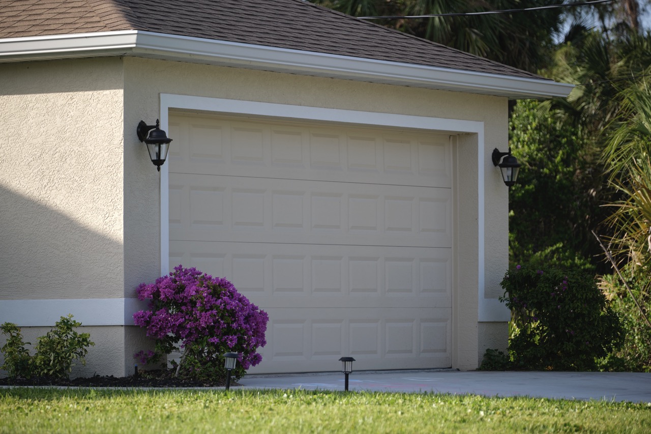 Wide garage double door and concrete driveway of new modern american house.